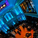 Elegant evening event at Boston Exchange Conference Center with guests mingling under blue and purple lights.