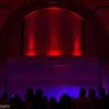 Guests dancing under red uplighting at a romantic Boston wedding reception.