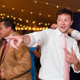 Young man dancing joyfully at Newagen Seaside Inn wedding reception in Southport, Maine.