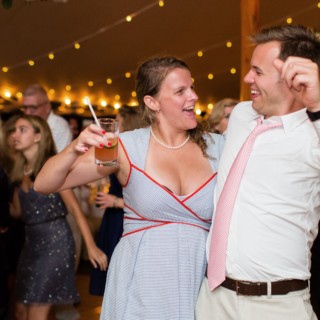 Couple dancing joyfully under string lights at Newagen Seaside Inn wedding in Southport, Maine.