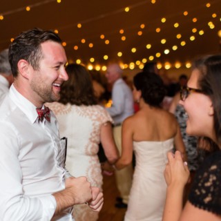 Laughing couple enjoying lively conversation at Newagen Seaside Inn wedding in Southport, Maine.