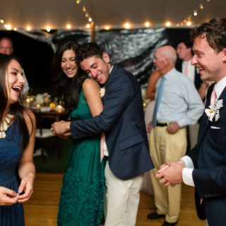 Guests laughing and celebrating at a joyful Newagen Seaside Inn wedding in Southport, Maine.