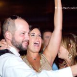 Joyful couple celebrating on the dance floor at a lively Block Island wedding reception.