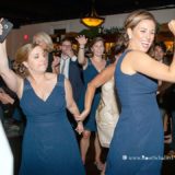 Bridesmaids dancing joyfully at a lively Block Island wedding reception celebration.