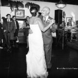 Father and daughter share a joyful dance at a black-and-white Block Island wedding reception.