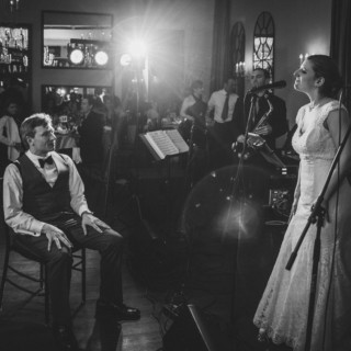 Bride singing to groom during romantic Alden Castle wedding reception in Brookline, Massachusetts.