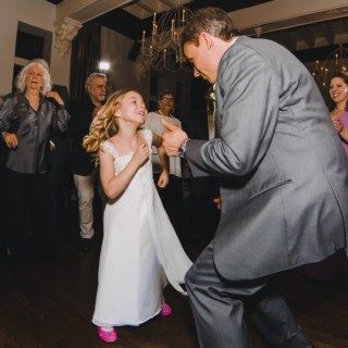 Flower girl dancing with father on lively wedding dance floor at Alden Castle, Brookline MA.