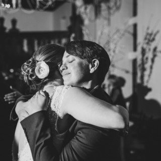 Black-and-white photo of a heartfelt wedding embrace at Alden Castle in Brookline, Massachusetts.
