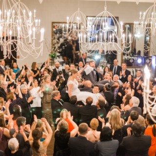 Bride and groom lifted during joyful Hora dance at elegant Alden Castle wedding in Brookline.