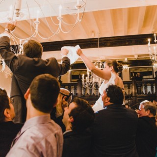 Bride and groom lifted during the joyful Jewish Hora dance at Alden Castle wedding.