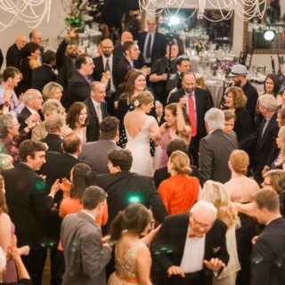 Bride dancing joyfully with guests at elegant Alden Castle wedding reception in Brookline, Massachusetts.