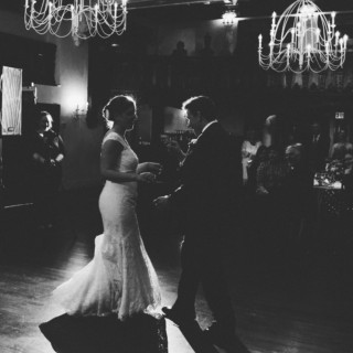 Bride and groom share a romantic first dance under chandeliers at Alden Castle wedding.