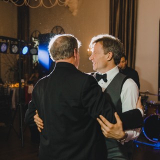 Father and son share a joyful dance at Alden Castle wedding in Brookline, Massachusetts.