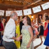 Joyful couple dancing at rustic Inn at Baldwin Creek wedding in Bristol, Vermont.