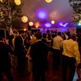 Guests dancing under glowing lanterns at an elegant Bar Harbor Maine wedding reception.