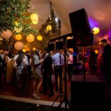 Evening wedding celebration with dancing guests and live band under glowing lanterns in Bar Harbor Maine.