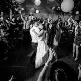 Bride and groom share a joyful first dance surrounded by cheering guests in Bar Harbor.