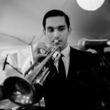 Black and white photo of a jazz trumpet player performing at an elegant wedding reception.