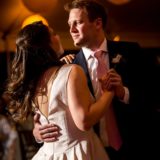 Bride and groom share a romantic first dance under warm golden lantern light in Bar Harbor.