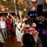 Guests dancing and celebrating under glowing lanterns at a joyful Bar Harbor wedding reception.