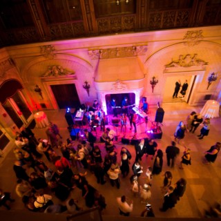 Elegant wedding reception with live band and dancing guests in the grand ballroom of Ochre Court.