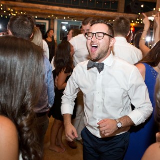 Man dancing and singing joyfully at Stone Mountain Arts Center wedding in Brownfield, Maine.