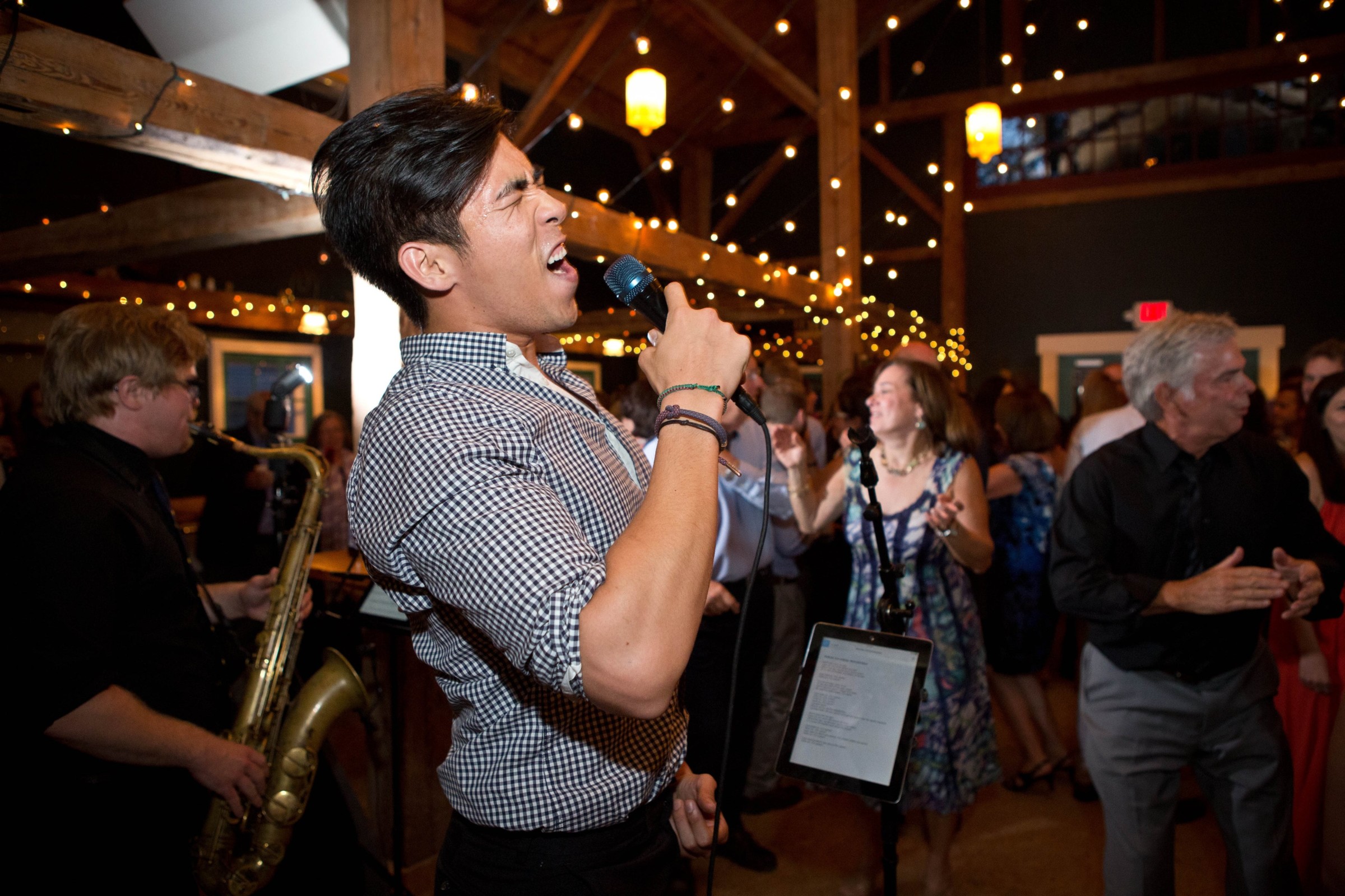 Energetic live band and singer performing at a joyful rustic wedding reception in Brownfield, Maine.