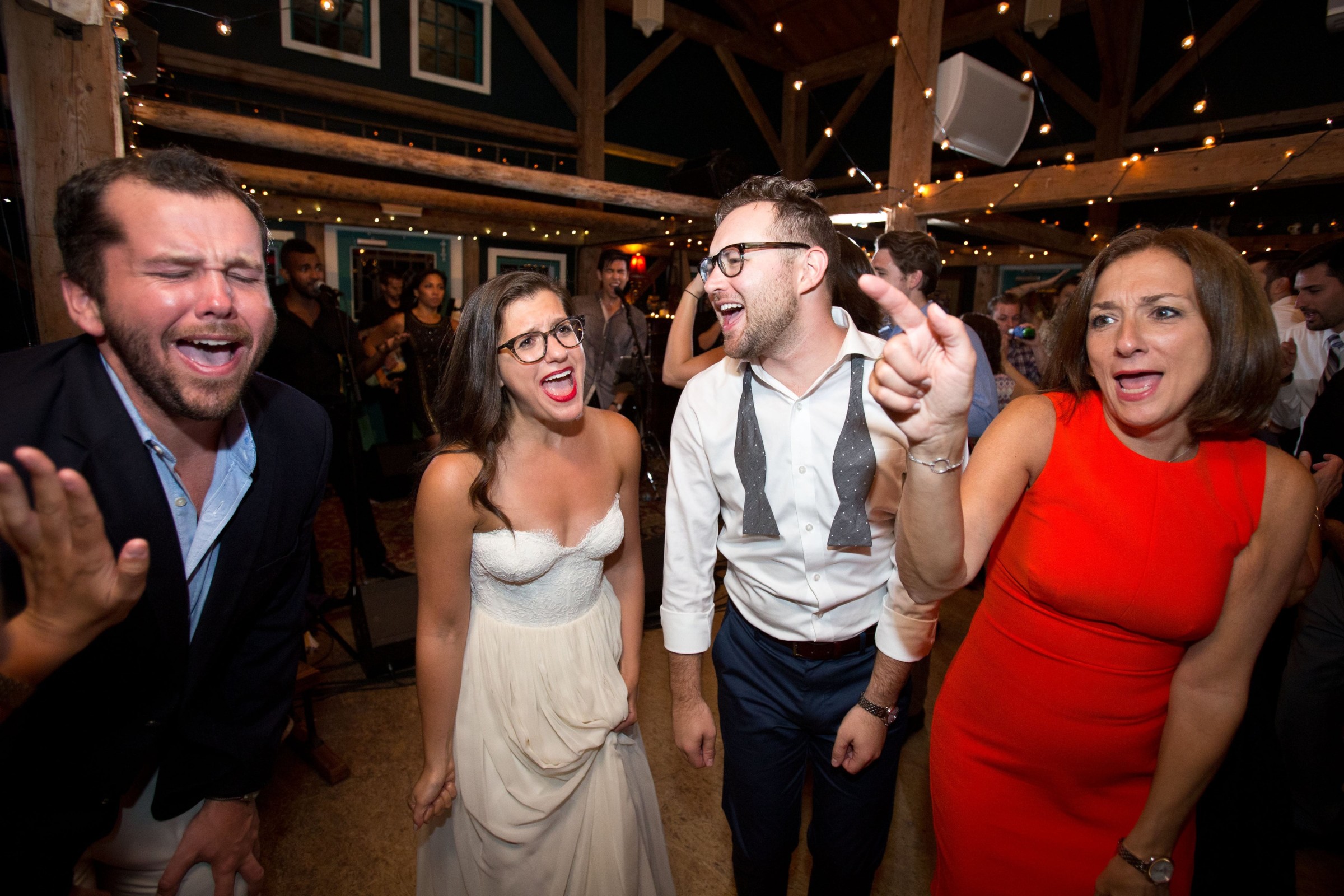 Wedding guests singing and dancing joyfully at Stone Mountain Arts Center in Brownfield, Maine.