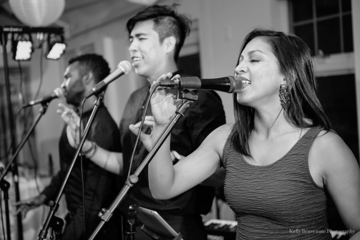 Black and white photo of three passionate wedding singers performing at Duxbury Bay Maritime School.