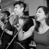Black and white photo of three passionate wedding singers performing at Duxbury Bay Maritime School.