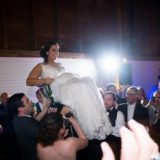 Bride lifted on a chair during joyful wedding celebration at Gedney Farm in New Marlborough.