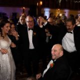 Bride and guests share a joyful circle dance at Gedney Farm wedding in New Marlborough.