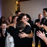 Bride hugging loved one amid joyful celebration at Gedney Farm wedding in New Marlborough, Massachusetts.