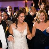 Bride, groom, and guests joyfully dancing at Gedney Farm wedding in New Marlborough, Massachusetts.