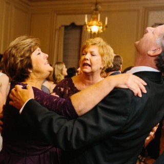 Elderly friends joyfully dancing at elegant Crane Estate wedding reception in Ipswich, Massachusetts.