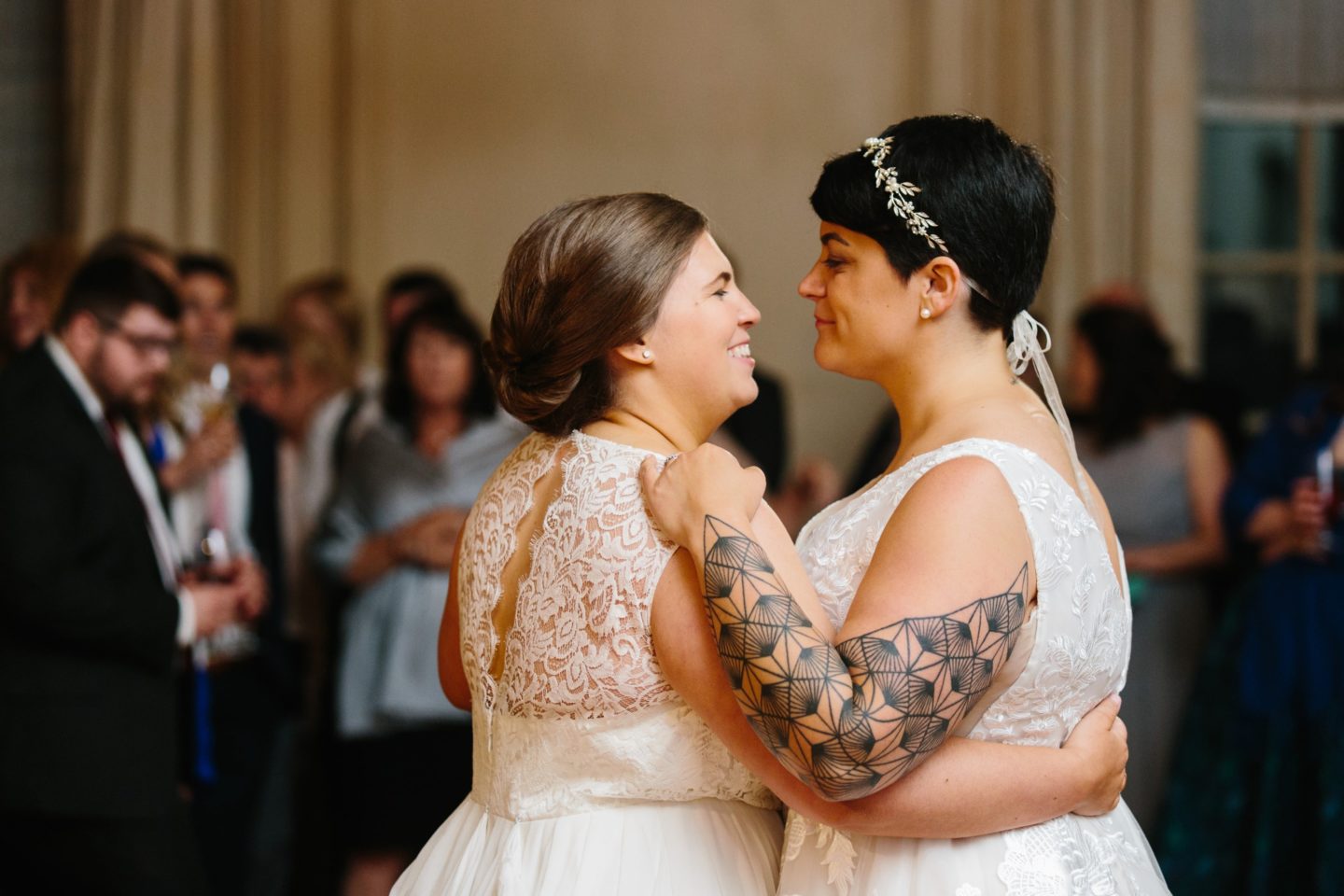 Two brides share a romantic first dance at their elegant Crane Estate wedding in Ipswich, Massachusetts.