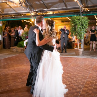 Bride and groom share a romantic first dance under glowing string lights in Philadelphia wedding.