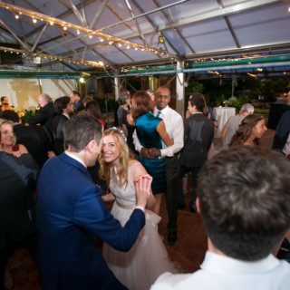 Bride and groom dancing at Fairmount Park Horticulture Center wedding in Philadelphia under glowing lights.