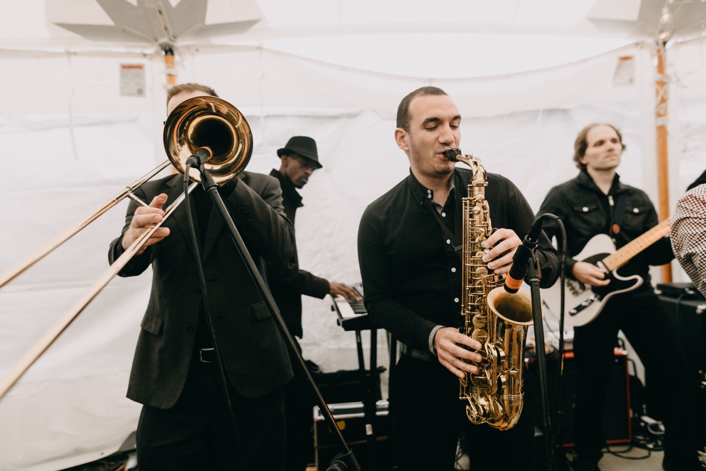 Live jazz band performing under a white canopy at an outdoor wedding celebration in Newbury, MA.