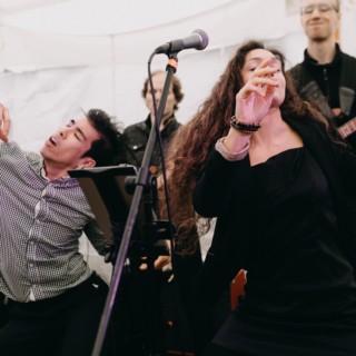 Energetic live band performing passionately at Spencer-Peirce-Little Farm outdoor wedding in Newbury, Massachusetts.