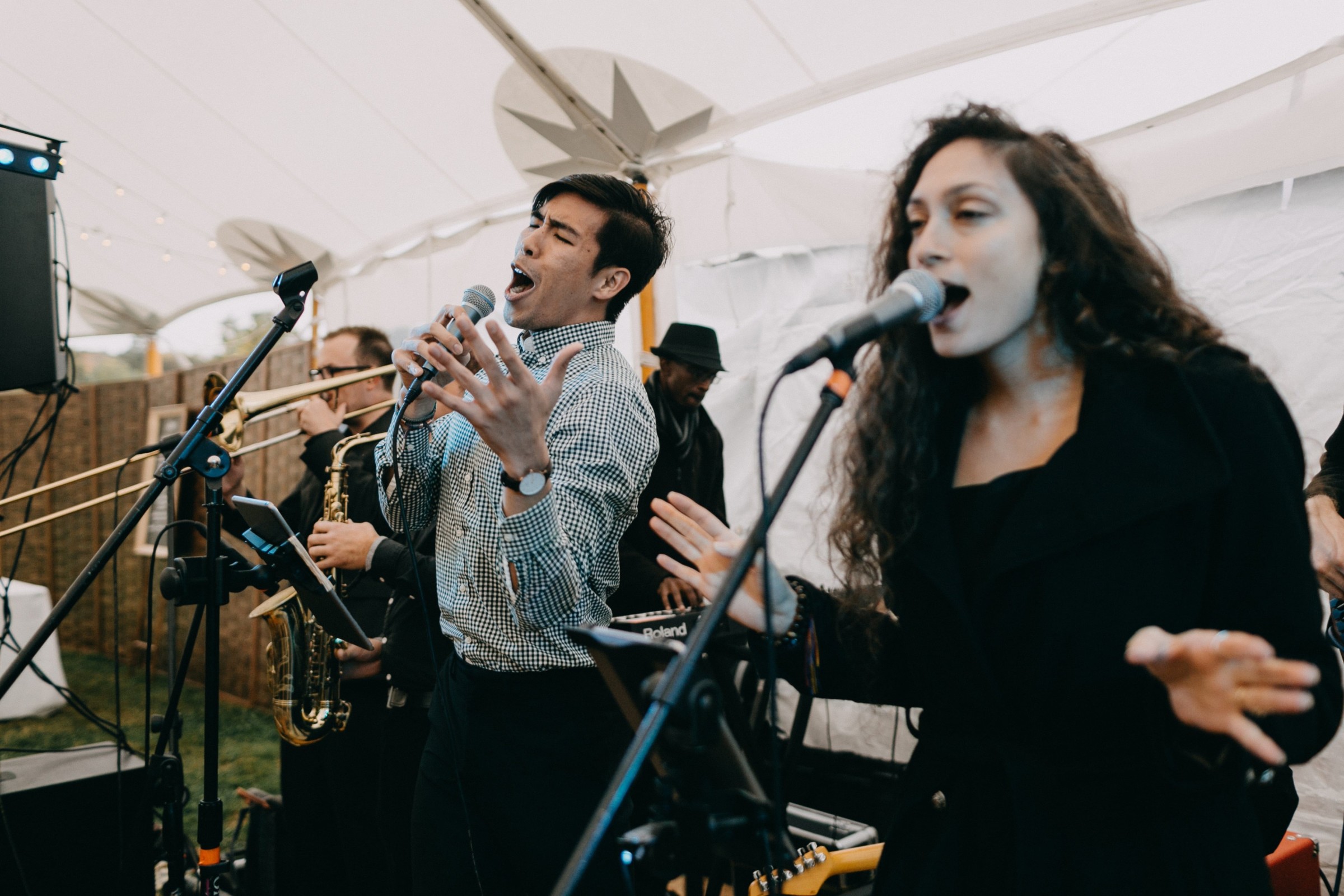Live band performing under white canopy at outdoor wedding reception in Newbury, Massachusetts.
