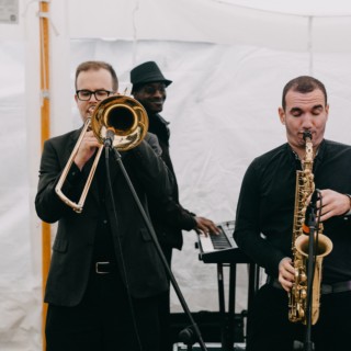 Jazz band performing live under a white wedding tent in Newbury, Massachusetts.