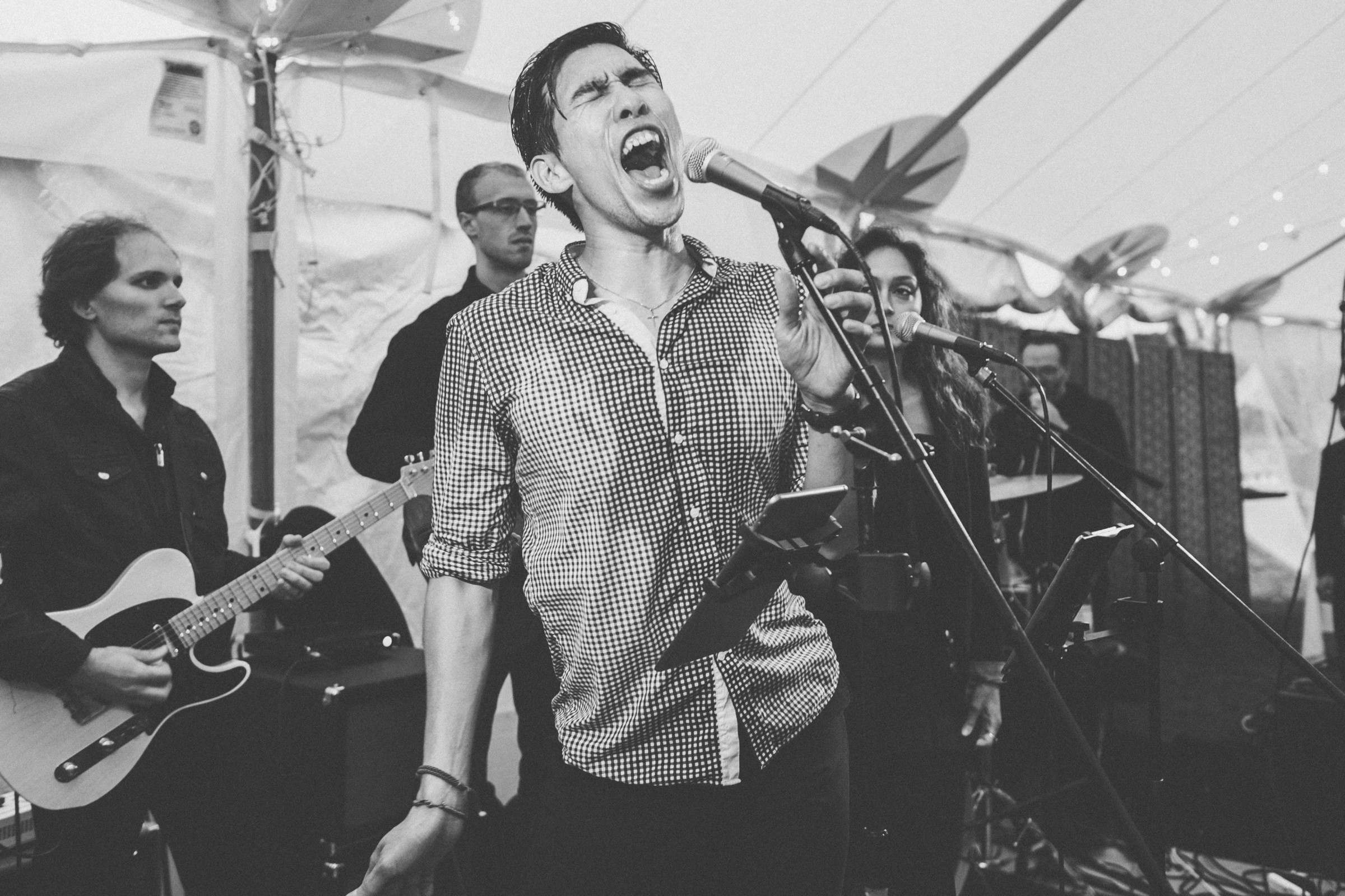 Black and white photo of passionate live band performing at Spencer-Peirce-Little Farm wedding.