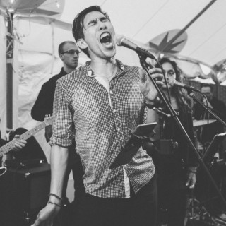 Black and white photo of passionate live band performing at Spencer-Peirce-Little Farm wedding.