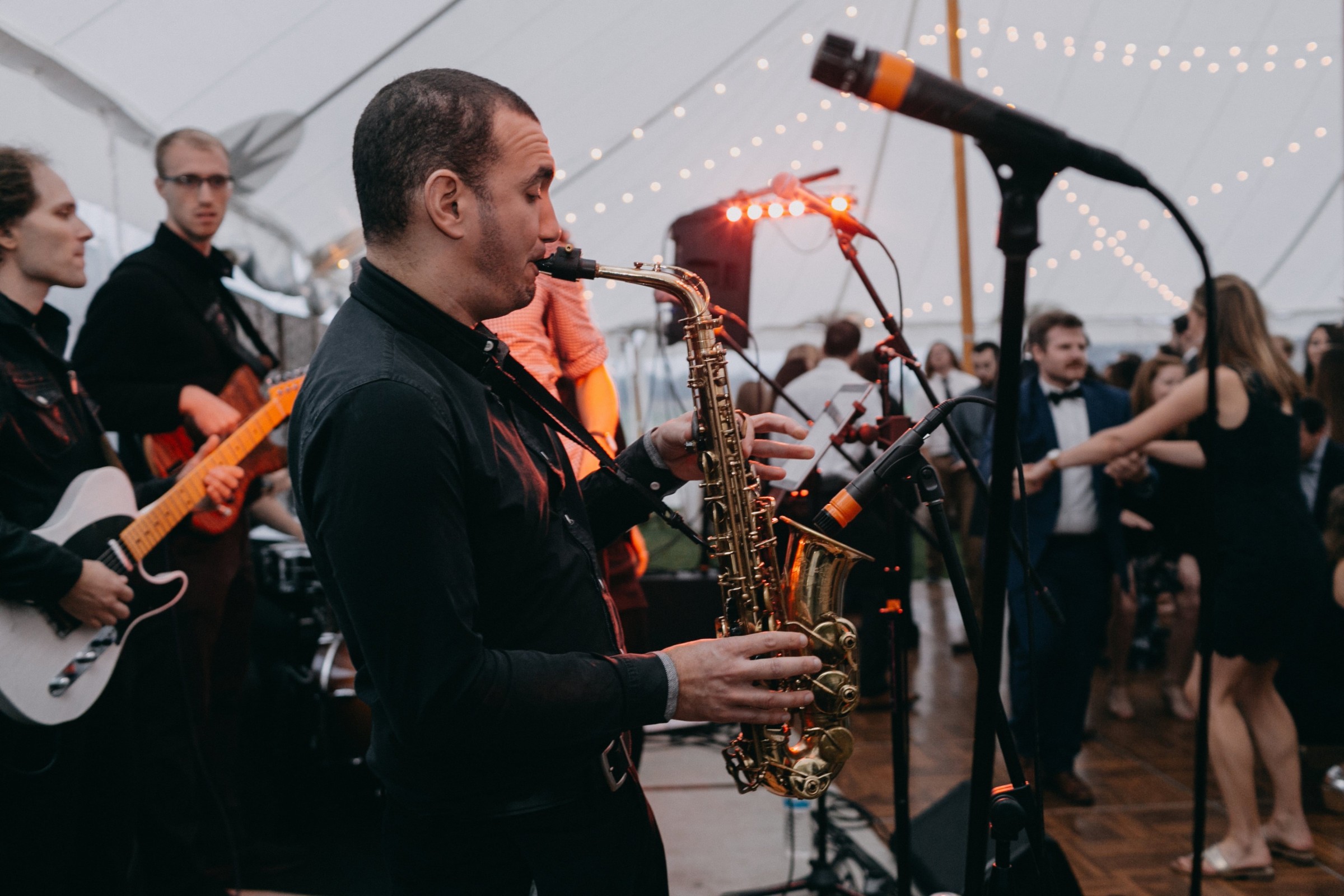 Live band performing under glowing lights at an elegant outdoor wedding reception in Newbury, Massachusetts.