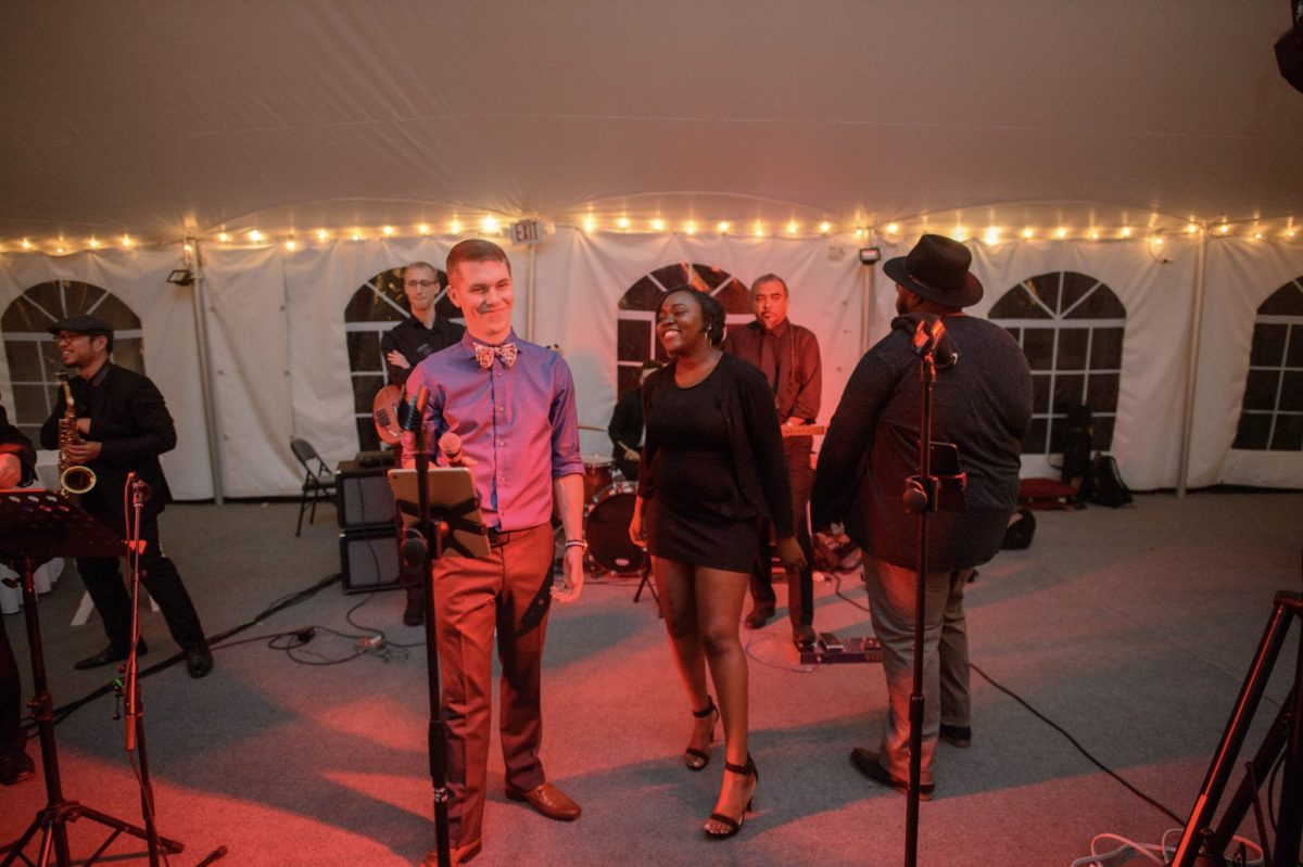 Live wedding band performing under string lights at Waterville Valley reception in New Hampshire.