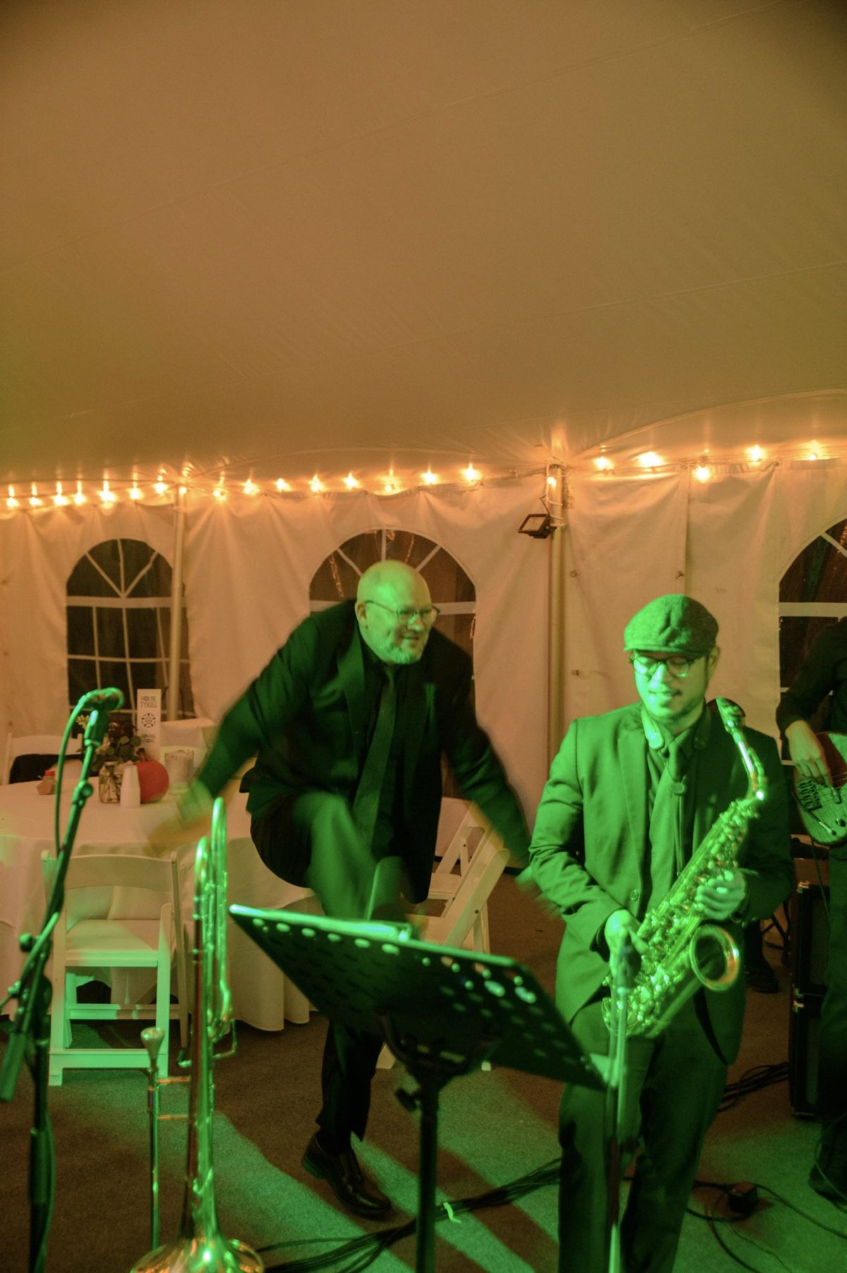 Energetic jazz musicians performing live under warm lights at a Waterville Valley wedding reception.