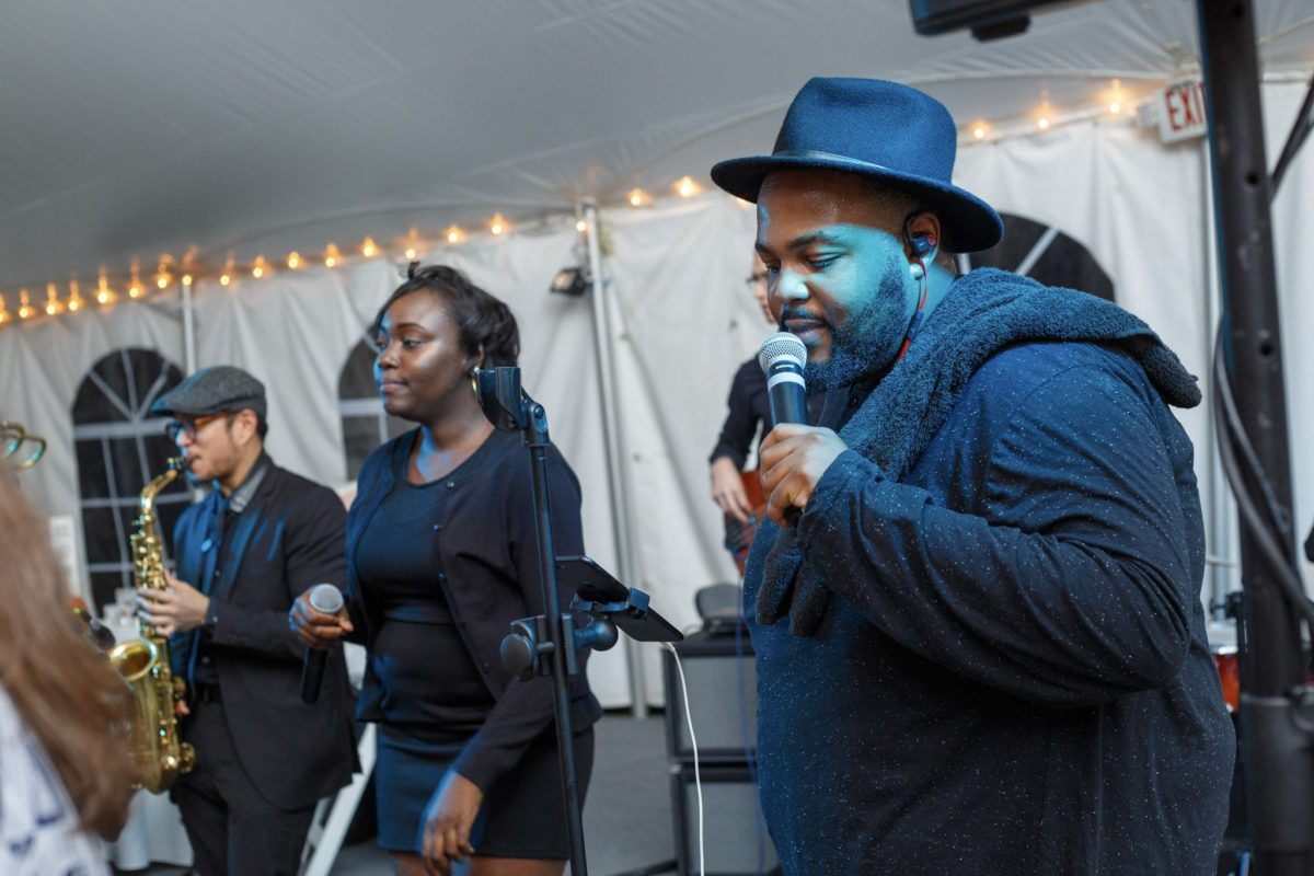 Live band performing under string lights at a Waterville Valley wedding celebration.