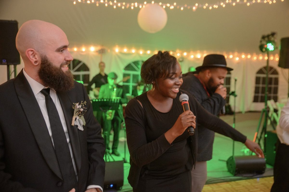 Joyful wedding reception with live band, laughter, and warm lights in Waterville Valley.