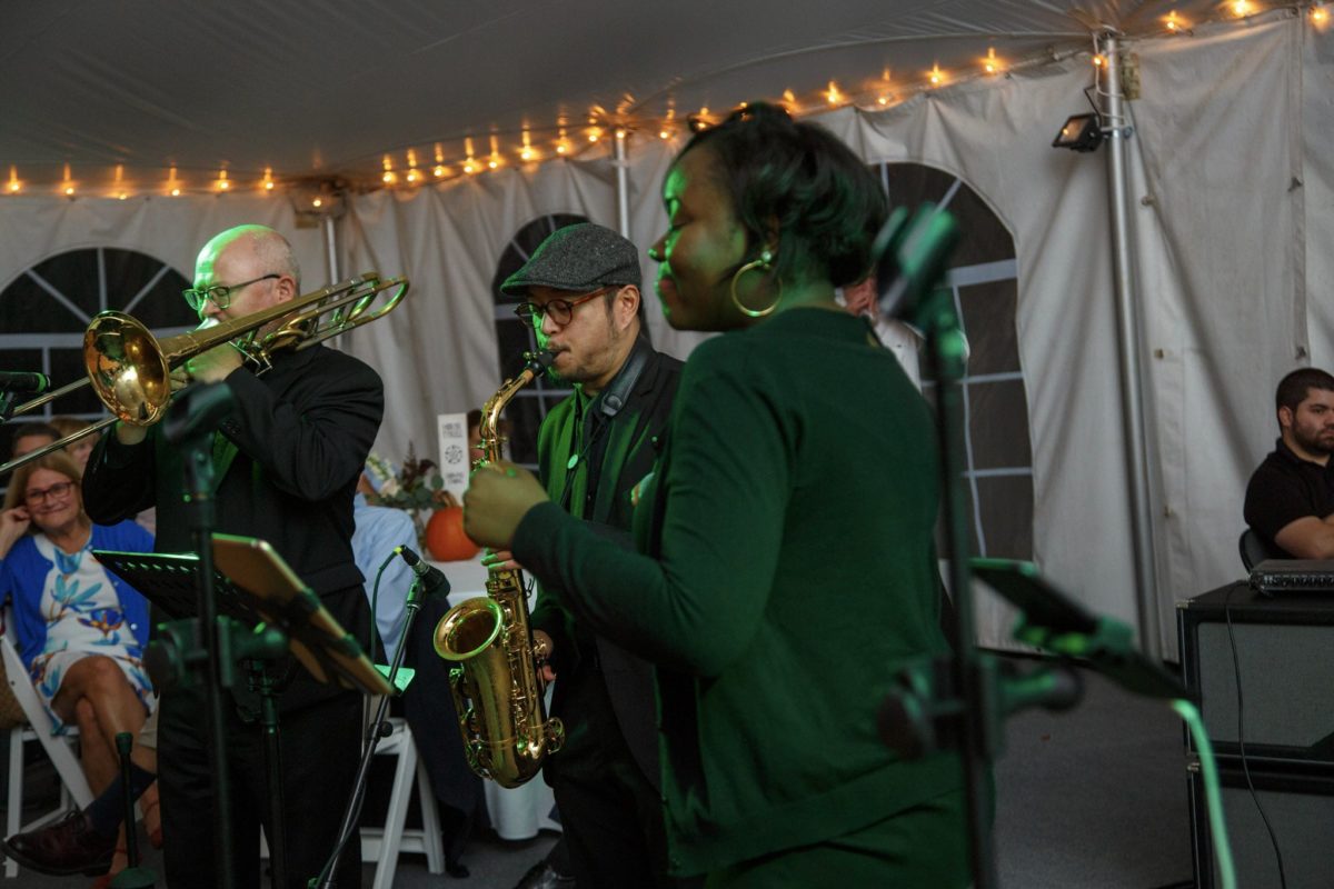 Live jazz trio performing under warm lights at an intimate fall wedding in Waterville Valley.